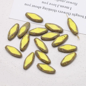 Macro detail of faceted yellow and brown striped spindle glass beads for DIY jewelry