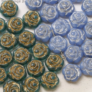 Detail of rose flower glass beads with vintage blue-green and gold-rimmed patterns