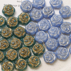 Detail of vintage rose glass beads with gold and silver edges for jewelry DIY