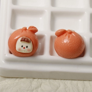 Macro view of cute 3D resin orange fruit charms for DIY hair accessories and crafts