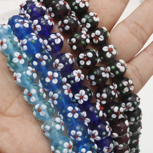 Macro detail of Millefiori glass flower beads in blue and brown for DIY jewelry making