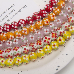 Close-up of colorful handmade lampwork glass flower beads for DIY jewelry making
