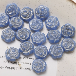 Macro shot of light blue rose beads with silver edges for DIY jewelry making