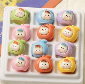 Colorful resin fruit baby charms in a grid display for DIY jewelry and hair accessories