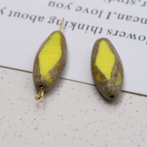 Macro detail of oval Czech glass beads with vintage textured patterns for DIY jewelry