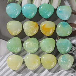 Detailed view of colorful marbled acrylic beads for DIY jewelry making in various shapes