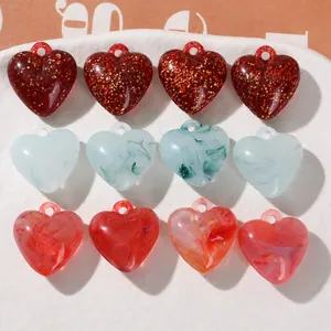 DIY jewelry parts featuring heart shaped acrylic charms with glitter and marble texture