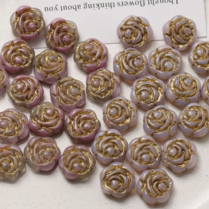 Macro detail of gradient purple Czech glass rose beads with vintage gold gilded edges