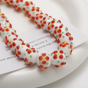 Detailed macro view of white floral glass beads for DIY necklaces and craft jewelry making