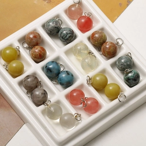 Macro view of 12mm natural stone round charms with silver metal loops for DIY jewelry making