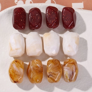 Detail showing faceted acrylic beads in glitter red, marble white and amber textures