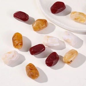 Macro shot of assorted marble-effect acrylic beads for DIY handmade jewelry crafting