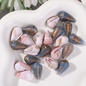 Mix of colorful pearlescent conch-shaped beads for DIY jewelry making in a heart bowl