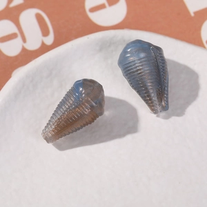 Macro detail of translucent blue acrylic conical beads with gold trim for jewelry making
