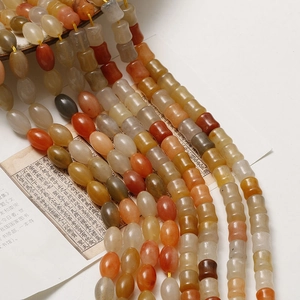 Detailed view of bamboo-shaped and oval natural agate beads for DIY jewelry making