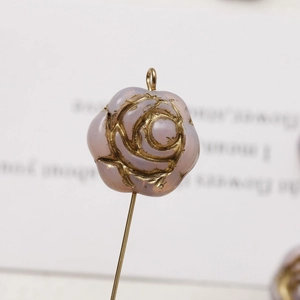 Macro shot of a light purple Czech glass rose bead with golden edges and a metal ring