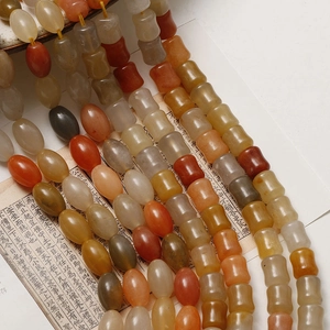 Detail of bamboo-style oval jade beads in warm earth tones for DIY jewelry making