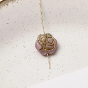 Detail of gradient light purple glass rose bead with gold engraving for DIY jewelry