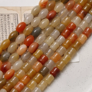 Close-up of polished oval and bamboo-shaped gemstone beads for DIY jewelry making