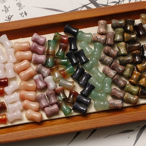 Macro shot of natural semi-precious beads in a wooden tray for jewelry DIY projects