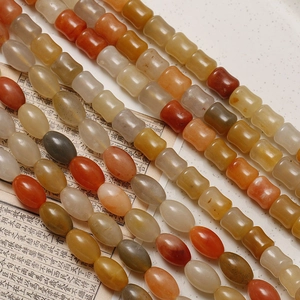 Macro detail of natural bamboo-shaped jade beads in various earth tones for DIY jewelry