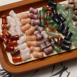 Macro detail of multicolored red agate and quartz bamboo-shaped beads for DIY jewelry making