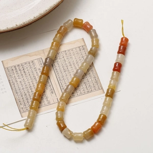 Detailed view of bamboo-shaped agate beads for DIY jewelry with natural warm tones