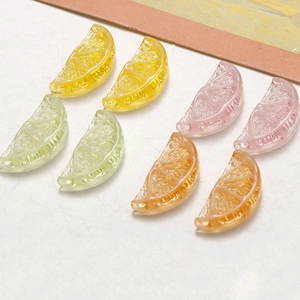 Close-up of translucent resin lemon and citrus slice pendants for DIY jewelry making