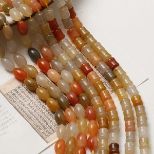 Bamboo and oval-shaped natural stone beads for DIY jewelry making on vintage paper
