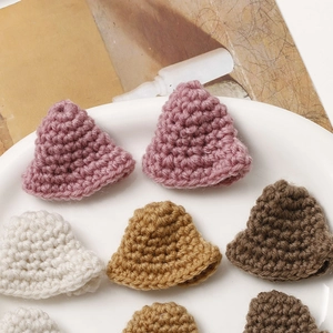 Close-up of handmade crochet mini bucket hats in various colors for DIY doll accessories