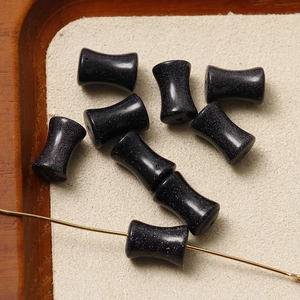 Macro detail of hourglass-shaped blue sandstone beads with sparkling finish for DIY jewelry