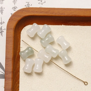 Macro detail of white and pale green dumbbell-shaped stone beads for DIY jewelry making
