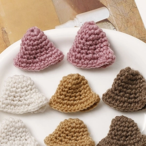 Macro detail of miniature crochet sun hats for DIY hair accessories and craft materials