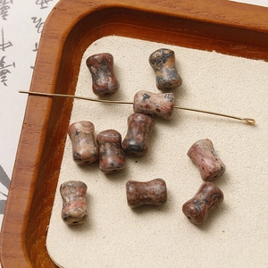 Macro shot of drum-shaped natural red agate stone beads with marbled texture for DIY jewelry