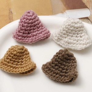 Detailed close-up of mini hand-crocheted bucket hats in four assorted autumn colors