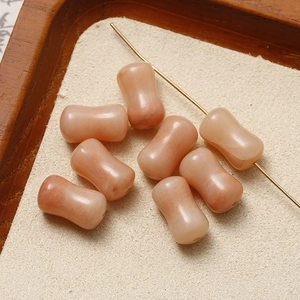 Detailed view of pink rose quartz cylinder beads for DIY jewelry making and necklaces