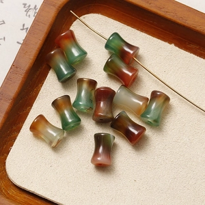 Detailed view of waist-drum shaped natural agate beads for DIY jewelry making