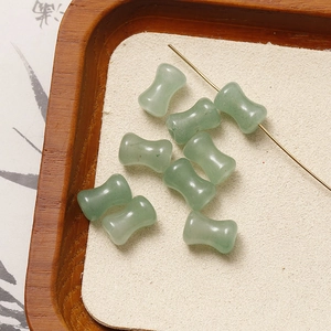 Macro shot of light green bamboo-shaped natural stone beads with smooth polished texture