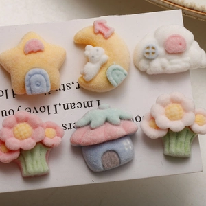 Close-up of cute flocked resin DIY charms with stars, bunnies and cloud cottage shapes