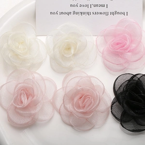 Detailed view of six layered mesh rose flowers in white pink and black for DIY crafts