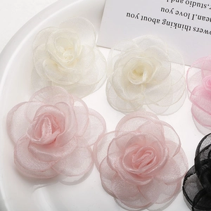 Detail view of multi-layered mesh fabric rose flowers for DIY brooches and hair accessories