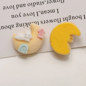 Detail of yellow moon and rabbit DIY resin charms with flocked and smooth textures