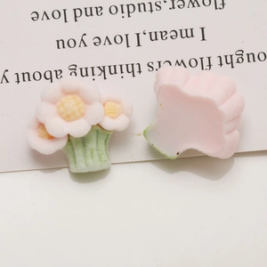 Detailed view of pink flocked flower charms with flat backs for DIY jewelry projects
