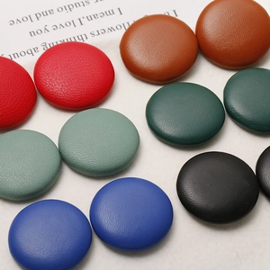 Assorted circular faux leather buttons in various colors for DIY hair accessories
