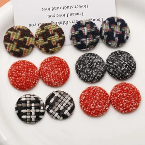 Macro detail of retro tweed fabric covered round buttons for DIY craft hair accessories
