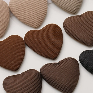 Macro shot of minimalist fabric heart-shaped buttons for DIY hair clips and crafts