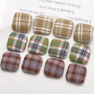 Detailed grid of 12 square checkered fabric buttons for DIY earrings and hair accessories