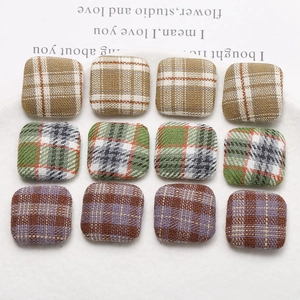 Close-up of 12pcs square plaid fabric buttons for DIY earring and hair clip materials