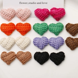 Flat lay of colorful knitted heart buttons for DIY hair accessories and craft making