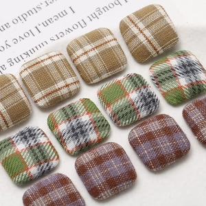 Macro shot of assorted vintage plaid fabric buttons for DIY earrings and hair accessories